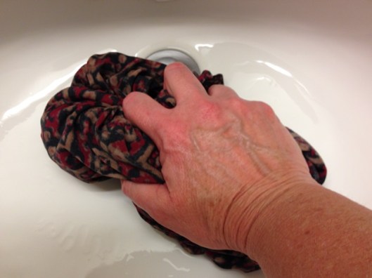 squeeze the water out of the garment