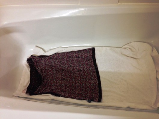 Lay the garment out on a towel