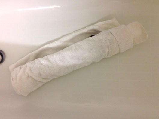 Roll the garment up in the towel to squeeze out excess water