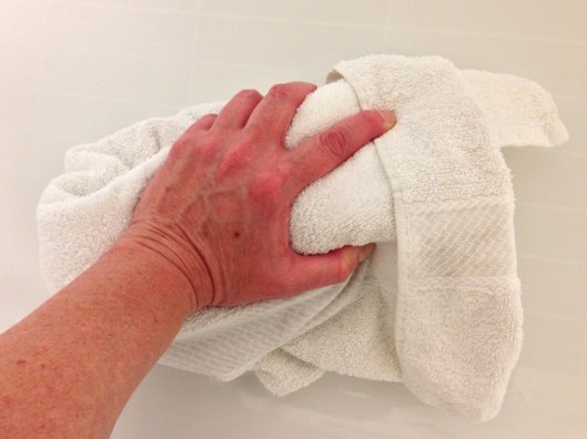 fold the rolled up towel in half